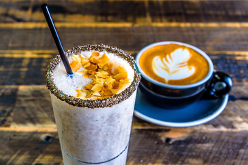 A bright cafe breakfast setting featuring a banana smoothie