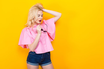 Blonde woman in pink blouse with sunglasses