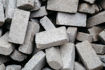 Stack of gray clay bricks for construction