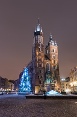 Fototapeta premium Krakow, Poland, Christmas tree and St Mary's church on Main Market square
