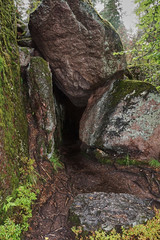 Obraz premium Composition natural/Large and small boulders create a beautiful composition in the form of a grotto (cave). Natural park 