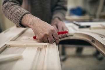 Close up shot of old master carpenter working in his woodwork or workshop