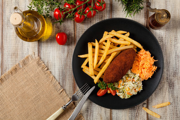Chicken Kiev (de Volaille chop) with french fries and salads.