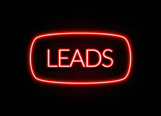 Leads neon sign on brick wall background.