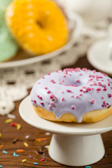 Colorful donuts on a wooden background.