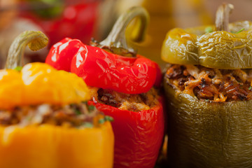 Colorful baked with cheese, stuffed peppers with rice and minced meat. - obrazy, fototapety, plakaty