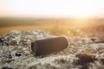 Сreative design portable wireless bluetooth speaker for music listening on sunset.