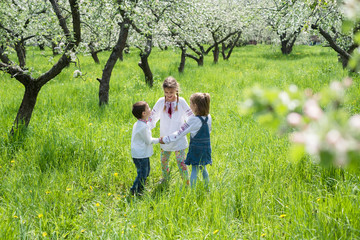 Fototapeta premium Children in embroidery in the garden
