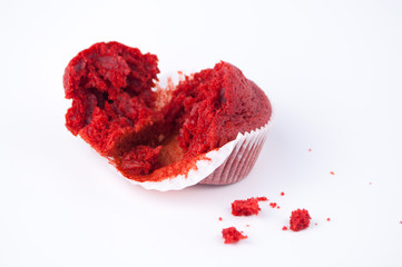 Broken cupcake red velvet on white buckground.