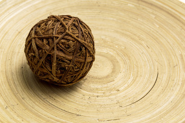 wicker ball on wooden plate