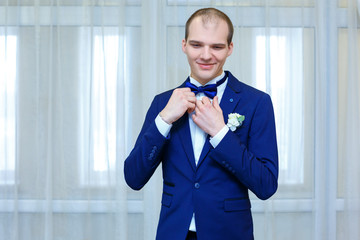 the groom in a blue suit