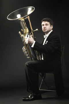 Tuba player brass instrument. Classical musician portrait