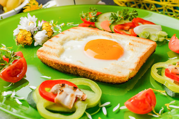 Fototapeta na wymiar Egg in toast bread baked in the shape of a flower with fresh vegetables and yogurt
