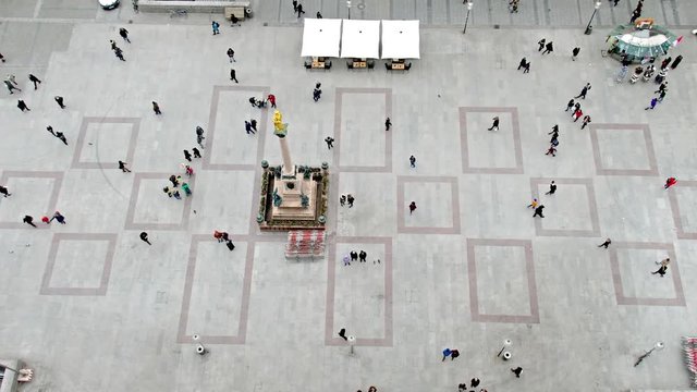 Aerial of people walking on square - time lapse