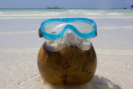 mask for swimming on a coco, on the beach of the island Borakay, Philippines