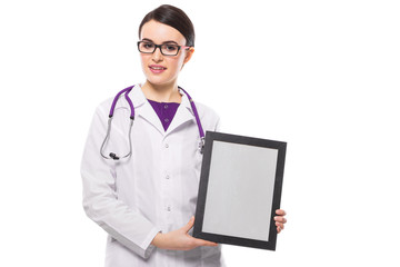 Successful young woman doctor with stethoscope showing frame in her hands in white uniform on white background