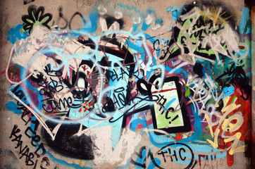 Close-up fragment of a graffiti drawing applied to the wall by aerosol paint. The wall is spoiled...