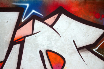 The old wall, painted in color graffiti drawing red aerosol paints. Background image on the theme...