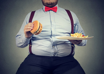Obese man eating fast food