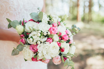 Wedding bouquet of roses in the hands of the bride.