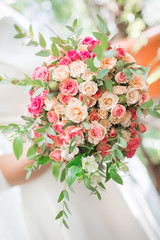 Wedding bouquet of roses in the hands of the bride.