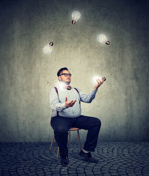Man fiddling with ideas light bulbs