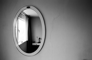 Vintage antique mirror on old wall black and white