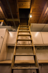 Stairs to the dark old attic in the wooden barn