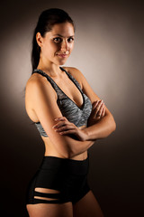 Active young fit woman pose in studio