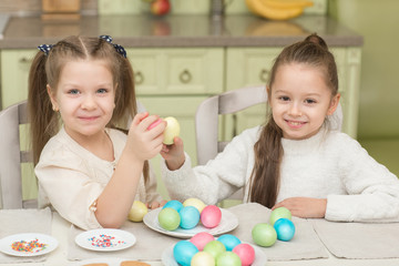 Cute smiling kids holding painted easter eggs