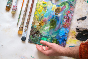 Set of artistic brushes, palette and paints.