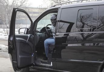 the criminal in the mask in the car