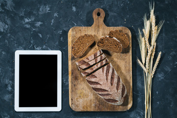 Fresh homemade bread with tablet