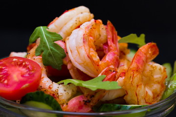 Food. Langoustines salad, black background