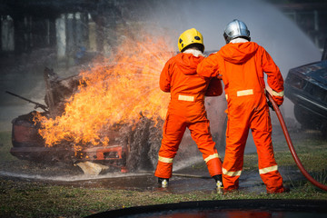 Firefighters training, Team practice to fighting with fire in emergency situation..Spray water to...