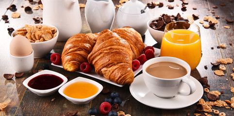 Breakfast served with coffee, juice, croissants and fruits