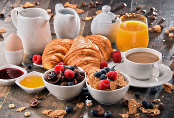 Breakfast served with coffee, juice, croissants and fruits