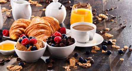 Breakfast served with coffee, juice, croissants and fruits