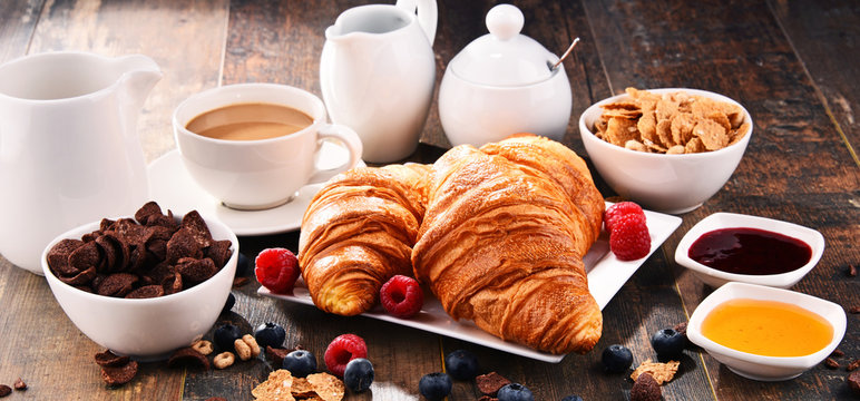 Breakfast served with coffee, croissants, cereals and fruits
