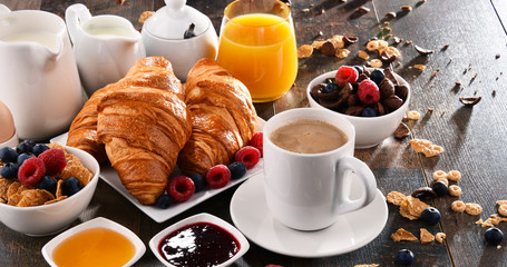 Breakfast served with coffee, juice, croissants and fruits
