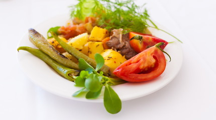 Food. Plate:  tomato, pepper, meat, leaves greenery, lamb