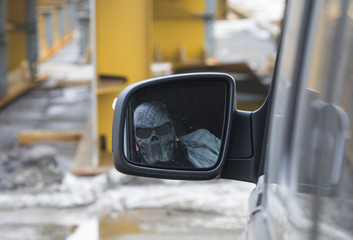 the criminal in the mask in the car