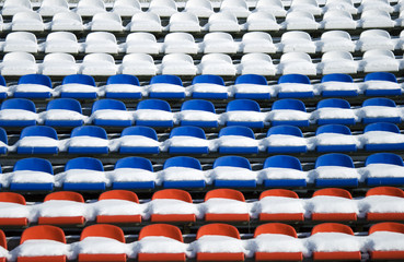 Fototapeta premium Empty snow-covered stands of the stadium