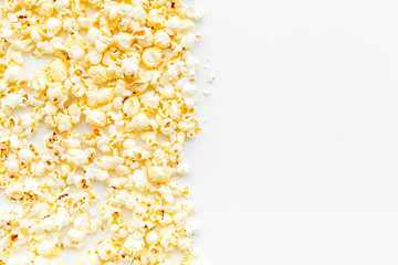 Obraz na płótnie Canvas Popcorn background on white top view copy space