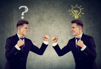 man with question mark fighting a guy with bright idea