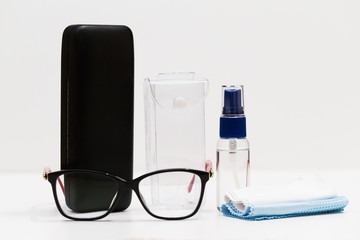 Glasses, spectacle case, liquid in a bottle, white background