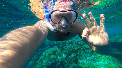 snorkler shows a gesture that is all right