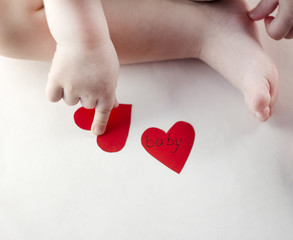 Fototapeta premium Handle and a baby's leg and a red heart