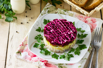 Homemade appetizer on the festive easter table. Salad with salmon, potatoes and beets.