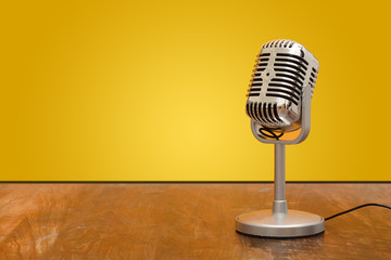 Retro style microphone recorder in studio with yellow background